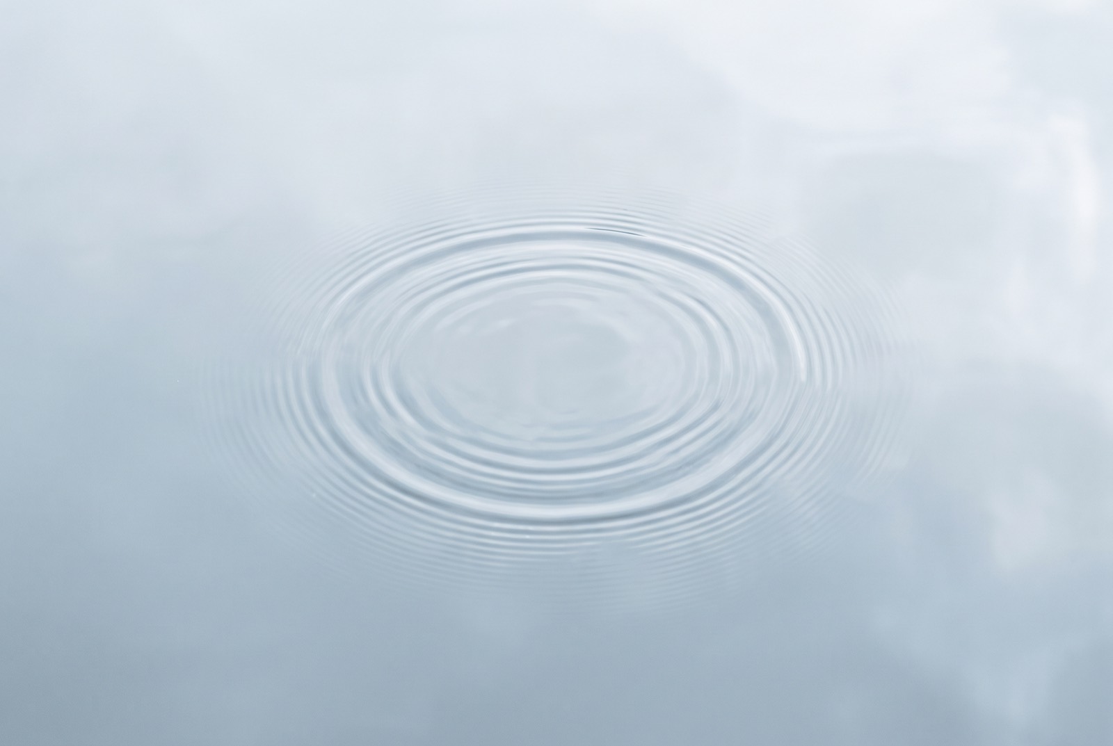 Concentric ripples spreading across still water
